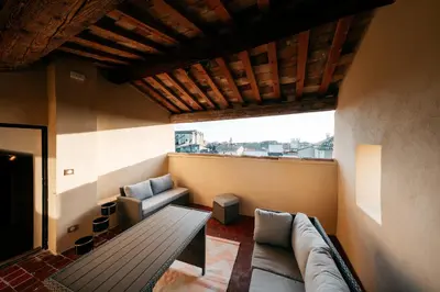 a living room with a couch and a table at Le Clos Violette et Le 11 D'Aglaé - Appart' Hôtel de Charme Design de Luxe in LʼIsle-sur-la-Sorgue