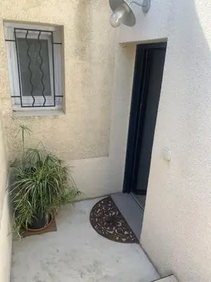 a door of a building with a window and a plant at studio avec exterieur in Eyragues