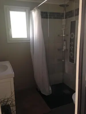 a bathroom with a shower with a shower curtain at studio avec exterieur in Eyragues