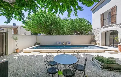 a patio with a table and chairs next to a swimming pool at Amazing Home In Vedène in Vedène