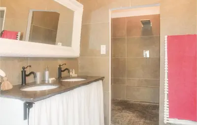 a bathroom with two sinks and a shower at Amazing Home In Vedène in Vedène