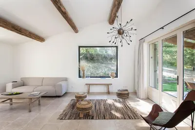 a living room with a couch and a table at Les Amandiers in Bonnieux