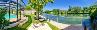 a view of a river with a swimming pool at Au Murmure de la Sorgue in LʼIsle-sur-la-Sorgue
