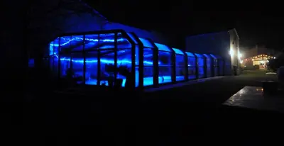a building with blue lights in the dark at Au Murmure de la Sorgue in LʼIsle-sur-la-Sorgue