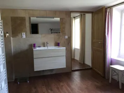 a bathroom with a white sink and a mirror at Maison de village Novissime in Noves