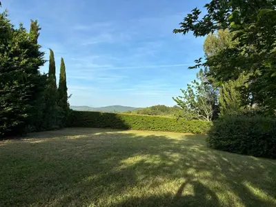 a garden with trees and a field of grass at La Fenice - Beautifully restored property with heated pool in small village in Montjustin
