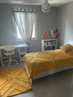 a bedroom with a bed and a desk and a chair at Villa Le Luberon in Mérindol