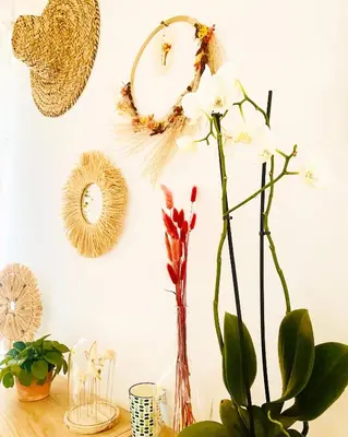 a table with a vase with flowers on a wall at villa Luberon in Saint-Saturnin-les-Apt