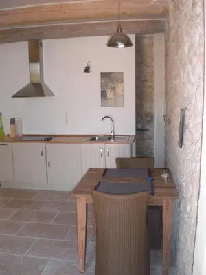a kitchen with a wooden table and a sink at Château de Peyrolles in Apt