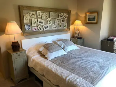 a bedroom with a bed with pictures on the wall at Provence Charm with Pool in Viens