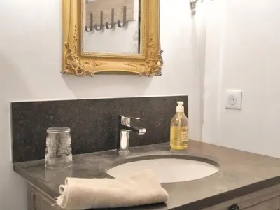 a bathroom sink with a mirror and a towel at Provence Charm with Pool in Viens