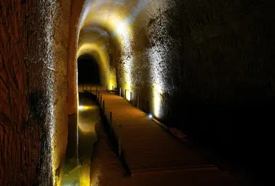 a dark tunnel with a row of tunnels with lights at Domaine Les Chênes Blancs in Saint-Saturnin-les-Apt