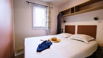 a bedroom with a bed with a hat on it at Domaine Les Chênes Blancs in Saint-Saturnin-les-Apt