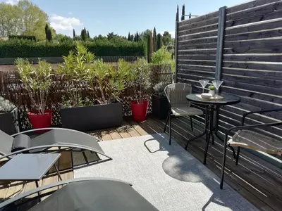 a deck with chairs and a swimming pool at Sweet Home Studio Aix en Pce, clim,terrasse,piscine,pkg gratuit in Aix-en-Provence