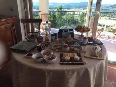 a table with a buffet of food on it at Le Logis in Gordes
