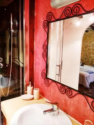 a bathroom with a sink and a mirror at Chambre d'hôtes face au lavoir in Méthamis
