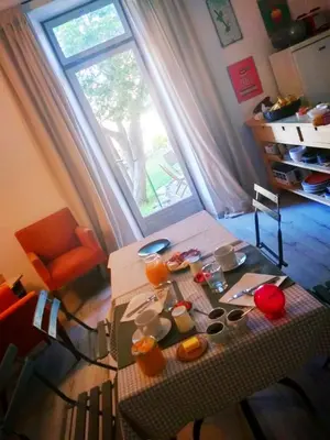 a room with a table and a large window at Chambre d'hôtes face au lavoir in Méthamis