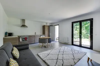 a living room with a couch and a table at Maison du Prignon in Saint-Marc-Jaumegarde