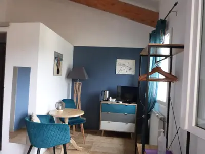 a room with a table and chairs and a desk at Mas Bastide st Victor à 5 mn de Lourmarin in Puyvert