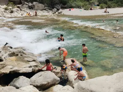 a group of people in the water at a beach at Gîte en Provence ''Rose'' in Modène