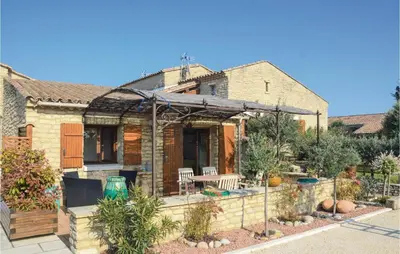 a house with a garden in front of it at Lovely Home In Gordes With Kitchen in Gordes