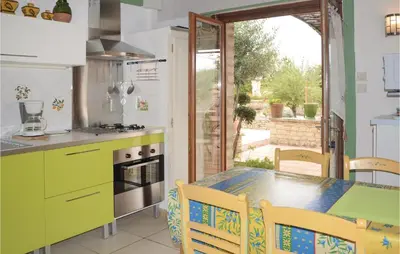 a kitchen with a table and chairs and a dining room at Lovely Home In Gordes With Kitchen in Gordes