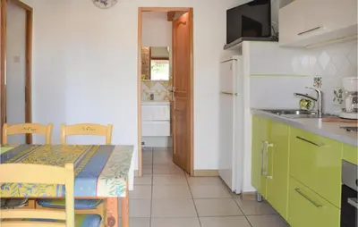 a kitchen with a table and a sink and a table and chairs at Lovely Home In Gordes With Kitchen in Gordes