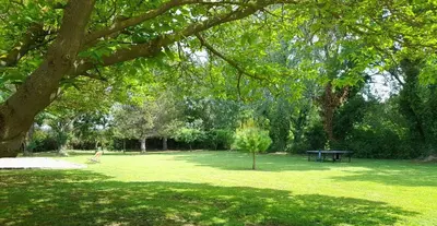 a park with a picnic table in the grass at Le Mas des Vergers in Salon-de-Provence