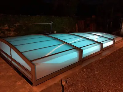 a blue bed with lights on top of it at L'Oustalado in Maubec