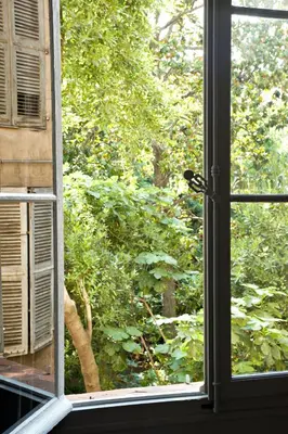 an open window with a view of a tree at Maison Dauphine in Aix-en-Provence