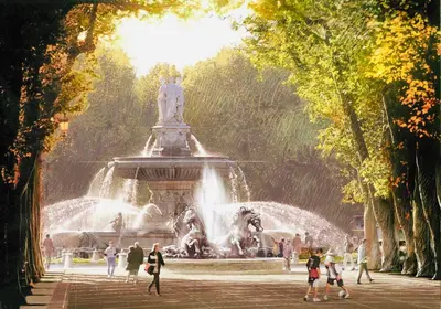 a fountain in a park with people walking around it at Montclar Studio in Aix-en-Provence