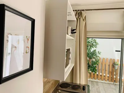 a mirror hanging on a wall next to a kitchen at Montclar Studio in Aix-en-Provence