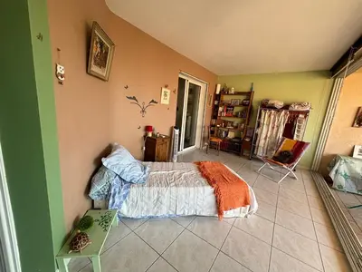 a bedroom with a bed with an orange blanket on it at Appartement 