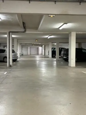 an empty parking garage with cars parked in it at Appartement 