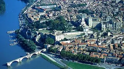 an aerial view of a city with a bridge over the water at Gite le Mas de l'Amandier in Saint-Saturnin-lès-Avignon