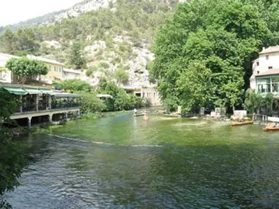 a river with people swimming in the water at Gite le Mas de l'Amandier in Saint-Saturnin-lès-Avignon