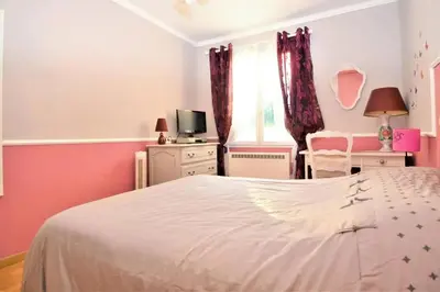 a bedroom with a white bed and a tv at Villa envoûtante à Eyragues avec piscine in Eyragues