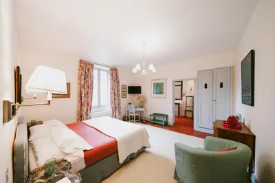 a bedroom with a bed and a chair at Bastide Rose in Le Thor