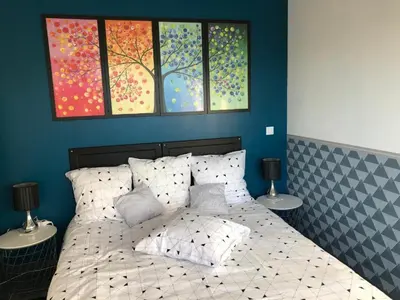 a bedroom with a bed with four windows at Chez Frédérique et Jean-Claude in Les Taillades