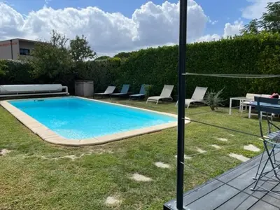 a swimming pool with lounge chairs and a table at Chez Frédérique et Jean-Claude in Les Taillades