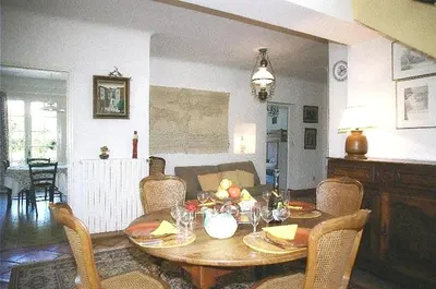 a living room with a table and chairs with a table and a table at Villa élégante à Céreste avec piscine privée et jacuzzi in Céreste