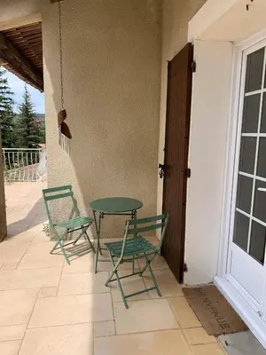 two chairs and a table on a patio at Villa élégante à Céreste avec piscine privée et jacuzzi in Céreste