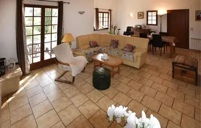 a living room with a couch and chairs and a table at Maison provençale avec cheminée à Loriol-du-Comtat, jardin privatif in Loriol-du-Comtat