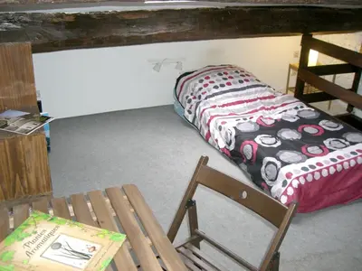a room with a bed and a chair in it at Maison charmante avec terrasse et jardin à Noves in Noves