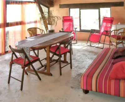 a wooden table and chairs in a room at Maison charmante avec terrasse et jardin à Noves in Noves