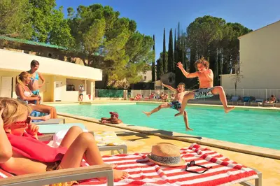 a group of children playing in a swimming pool at Résidence Goélia Le Domaine du Moulin Blanc in Gordes