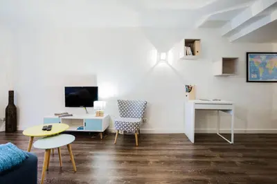 a living room with a couch and a table at LEYDET in Aix-en-Provence