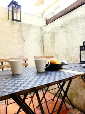 a table with two cups and a bowl of food on it at Les Bernardines in Aix-en-Provence