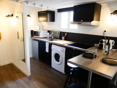 a kitchen with a washing machine and a washer at Les Bernardines in Aix-en-Provence