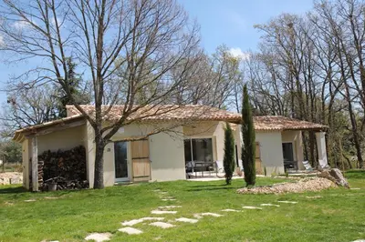 a small white house with trees in the yard at Le Fournil en Provence in Caseneuve